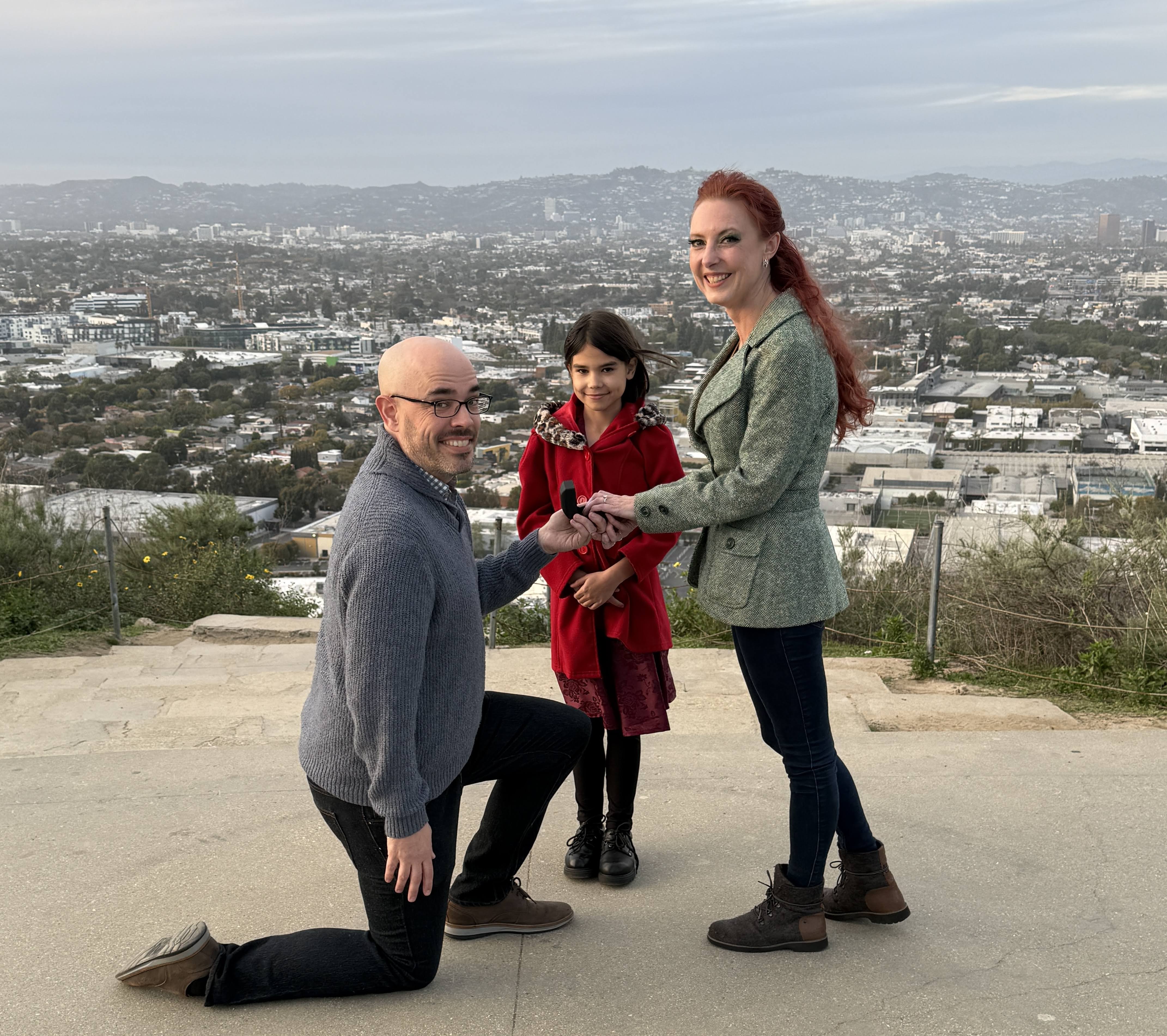 Sean kneeling with Fiona looking on
